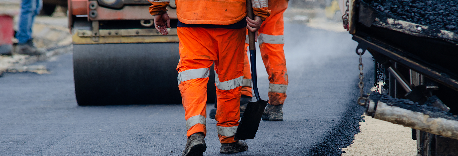 Workers laying new road banner image