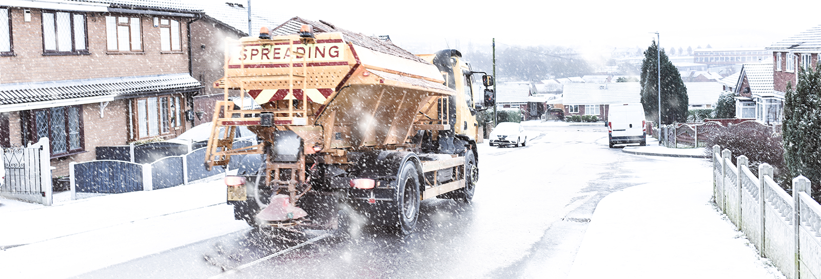 Gritting lorry on snowy road banner image